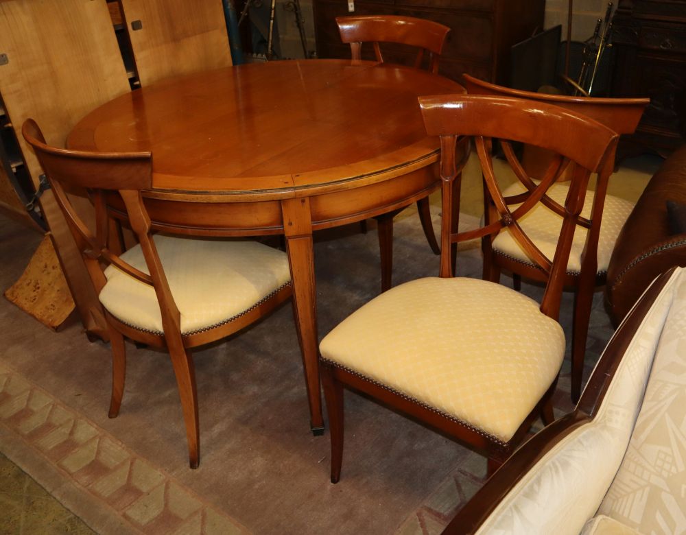 A modern cherrywood D ended extending dining table and a set of four chairs, table diameter 116cm